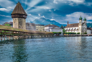 The Chapel Bridge (Kapellbrucke) a covered wooden truss footbridge spanning the River Reuss in the...