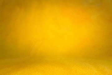 Sparkling photo studio background bright yellow. wall with floor