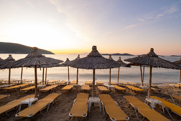 Fototapeta na wymiar Beach umbrella in the Greece, landscape with beautiful sunrise and summer beach