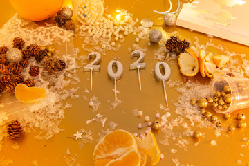  Year 2020 on silver background. Snowflakes with candles to create the year 2020 background.