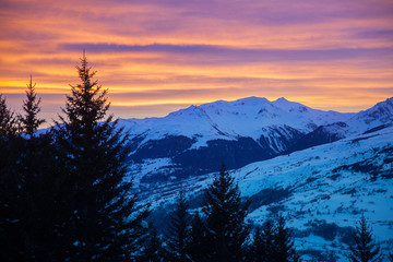 Cloudy sunset in winter Alps, Les Arc 1800 village, France