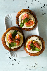 healthy gluten-free vegan cakes with sesame cookie base and cashew cream. with fresh figs. healthy cuisine