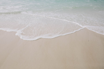 Fototapeta na wymiar Sand and Waves on Beach