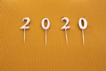  Year 2020 on silver background. Snowflakes with candles to create the year 2020 background.