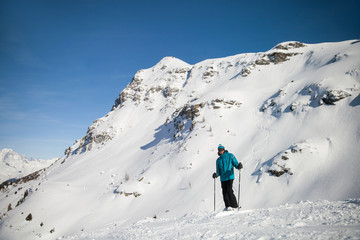Fototapeta na wymiar A skier on slope in alpine ski resort