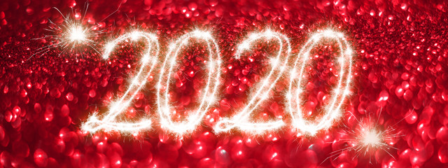 Fototapeta na wymiar Happy New Year 2020 banner. Number 2020 written sparkling sparklers on red background. Suitable for christmas, new year, chinese new year and designs