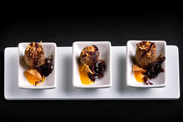 Canapes beef rolls with pumpkin sauce, on white plates