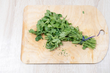 Parsley lies on the kitchen board
