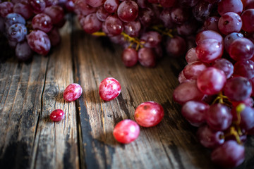 fresh organic red grape on old wooden vintage table