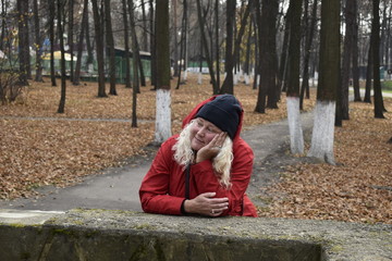 girl sitting on a bench in autumn park