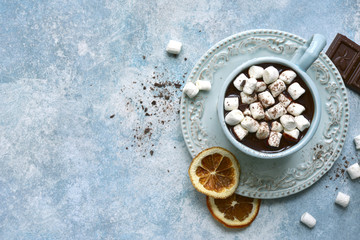 Homemade hot chocolate with orange and mini marshmallow .Top view with copy space.
