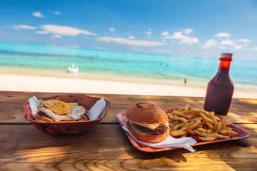 Beach fast food restaurant shake shack bar view of burger and french fries on table with view of...