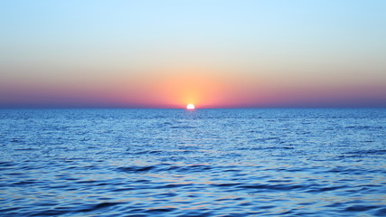 amazing sunset in the sea in blue and light colors
