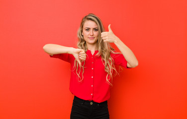 young blonde woman feeling confused, clueless and unsure, weighting the good and bad in different...