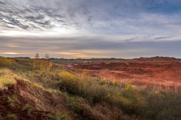 Red clay quarry - Blue sky during an autumn sunrise