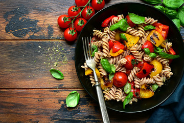 Whole wheat fusilli pasta with grilled vegetables. Top view with copy space.