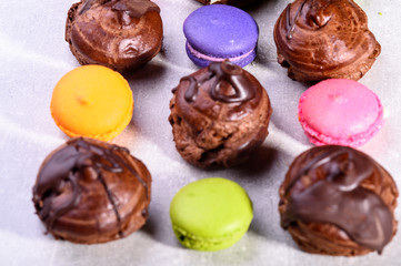 chocolate eclairs and colorful macaroons for the restaurant menu1