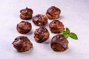 chocolate eclairs on a gray background in the kitchen11