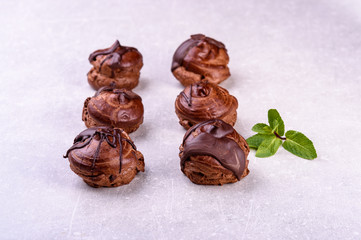  chocolate eclairs on a gray background in the kitchen7