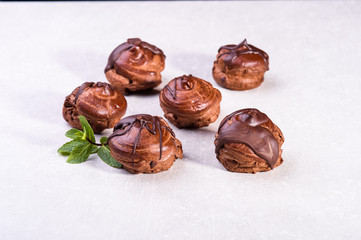  chocolate eclairs on a gray background in the kitchen3