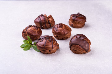  chocolate eclairs on a gray background in the kitchen2