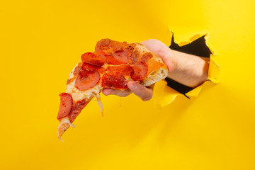 Hand giving a pizza slice