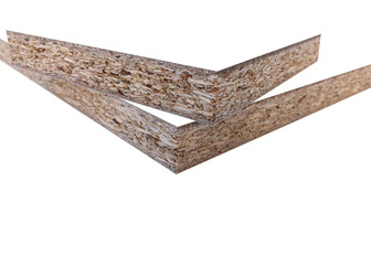 Wood chips and sawdust pressed into sheet material. On a white background with place for text. Uni color board. For the manufacture of cabinet furniture.