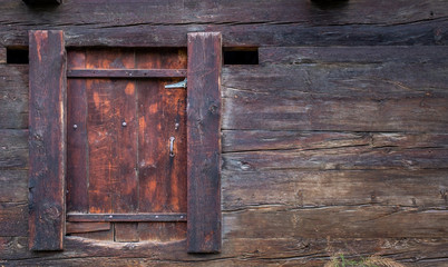 Door of an old weathered Swiss mountain hut. Textured.