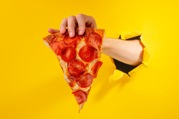 Hand showing a pizza