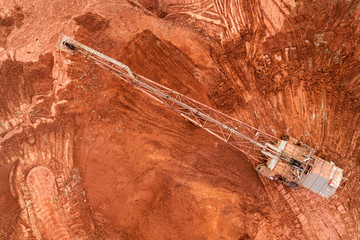 Aerial view of clay quarry with heavy machinery for digging. 