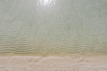 Drone photograph of waves and sandbar at beach