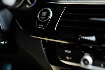 Obraz na płótnie Canvas Start stop button in a car, luxury car interior concept