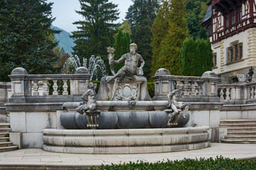 Fototapeta na wymiar Peles Castle, residence of King Charles I in Sinaia, Romania. Autumn landscape of royal palace and park.