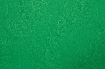 green artificial leather with waves and folds on PVC base