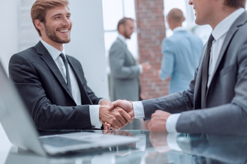 close up. handshake of business people near the office table
