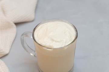 Close up image of cheese tea. Green tea topped with cream cheese foam on grey background