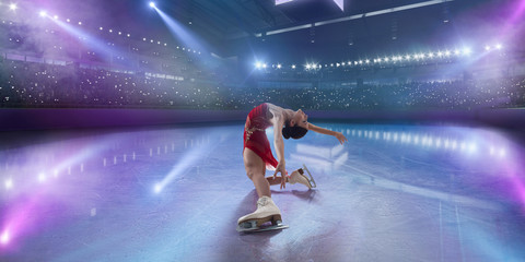 Figure skating girl in ice arena.