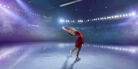 Figure skating girl in ice arena.