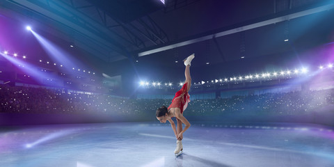 Fototapeta na wymiar Figure skating girl in ice arena.