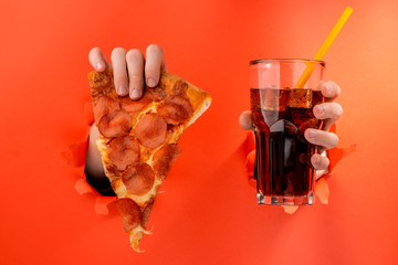 Hands showing pizza and cola