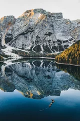 Wall murals Pale violet Autumn landscape of Lago di Braies Lake in italian Dolomites mountains in northern Italy. Drone aerial photo with Wooden boats and beautiful reflection in calm water at sunrise. Pragser Wildsee