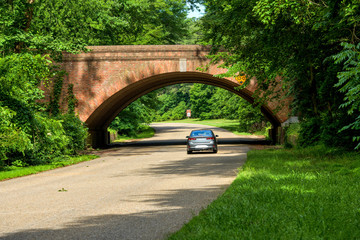 Colonial Parkway - A sunny Spring morning view of winding and scenic Colonial Parkway at one of its...