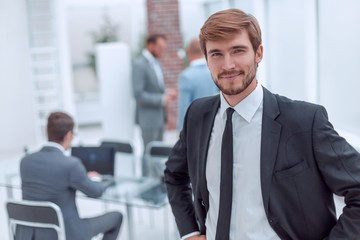 close up. smiling businessman standing in his office.