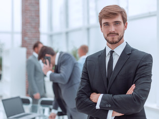 Fototapeta premium confident young businessman standing in the office