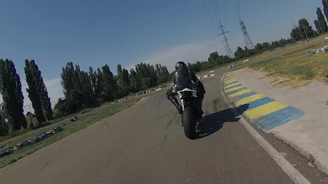 Motorcycle racing on asphalt track.