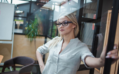 Business blonde in casual clothes in the office.