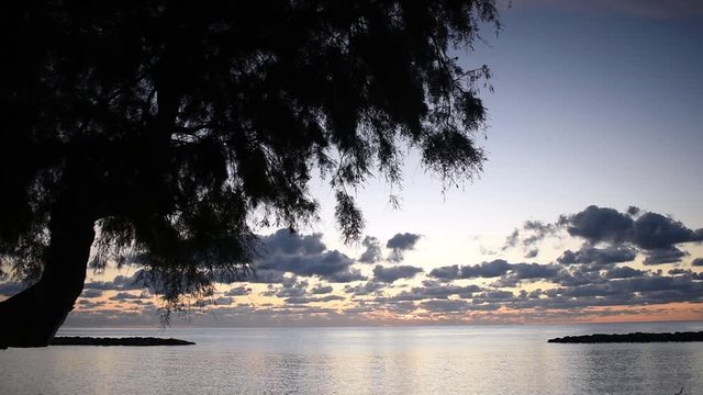 Cala Millor Mallorca a beautiful sunrise over the bay with reflections in the water.