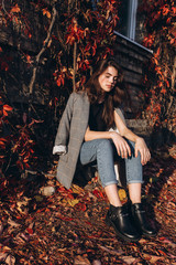 Close up portrait of young brunette stylish trendy girl outdoors in autumn park. Beauty, seasons, modeling, art, inspiration concept