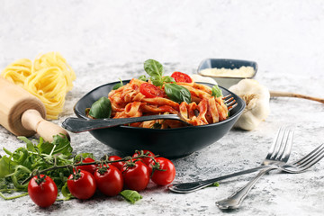tagliatelle pasta with tomato sauce parmesan basil on rustic background