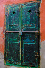 Sibiu, Romania, May 15, 2019: Traditional, colorful, decaying wooden courtyard doors of old townhouses in the center.